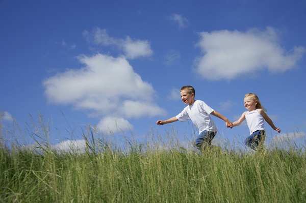 Boy and Girl Running in Tall Grass